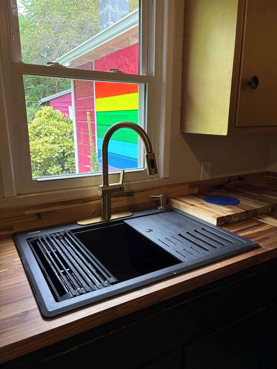 Sink has removable cutting board and drying rack.