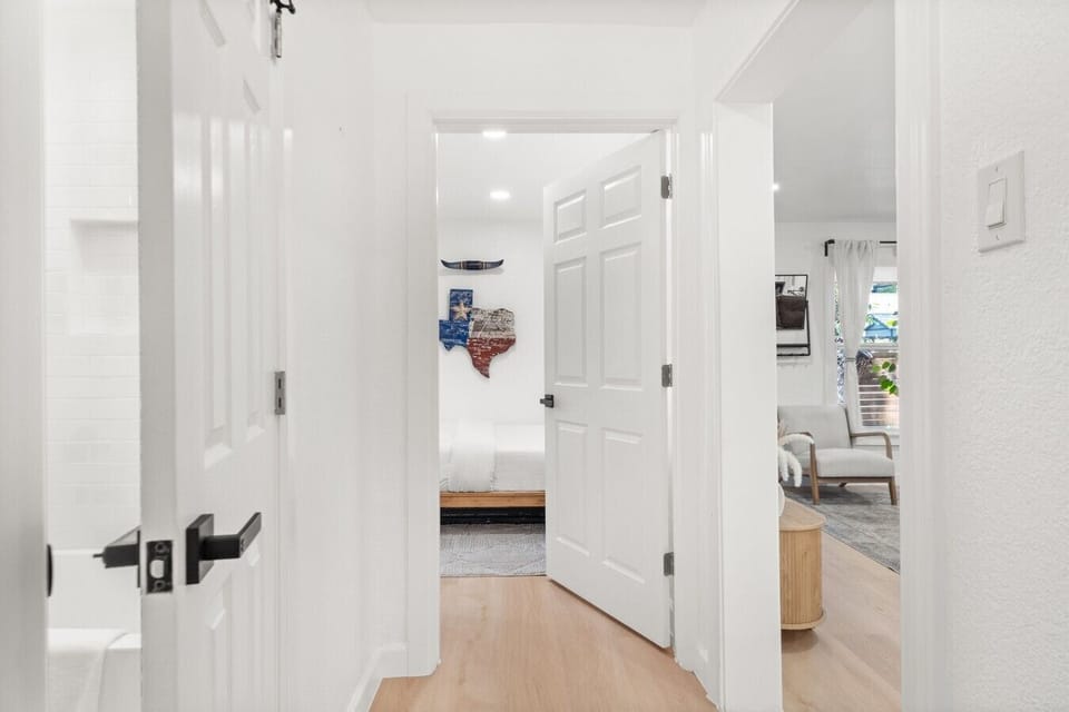 Bright hallways with Texas-inspired art connect the bedrooms to the shared living space.