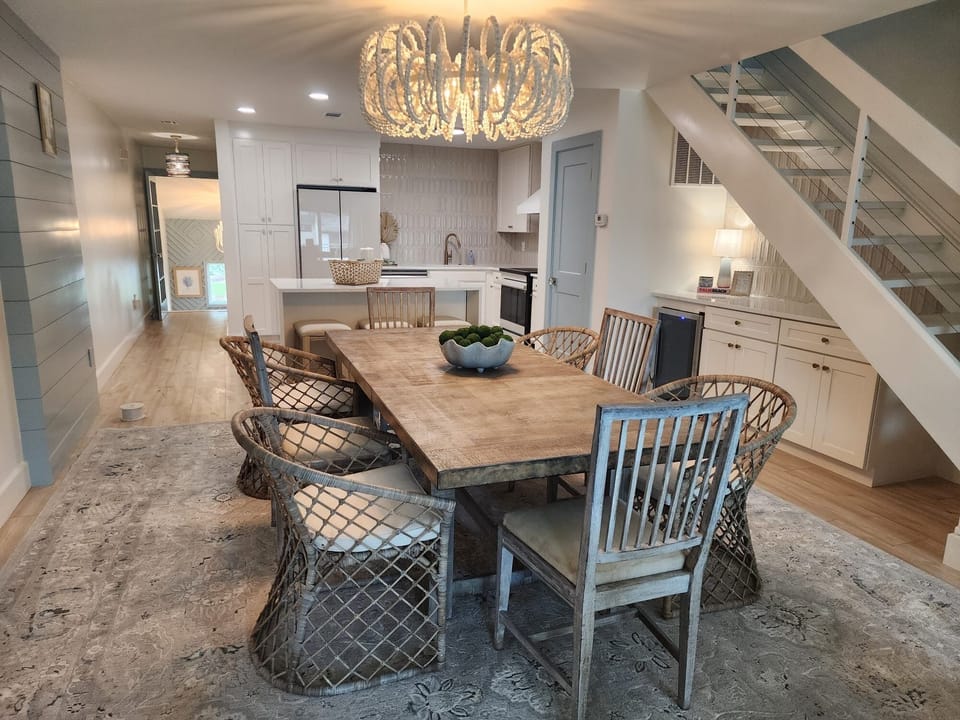 Bright designer dining space with statement lighting and open kitchen.