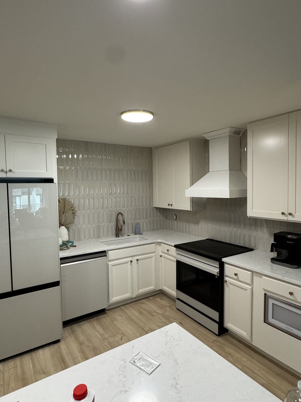 Bright modern kitchen with sleek finishes and plenty of prep space. Kitchen features abundant cookware, plates, silverware, drinkware, cooking utensils and pantry storage.  We include dishwashing soap, dishwasher pods and a sponge.