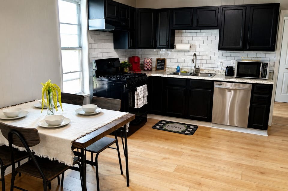 Modern kitchen with gas stove, dining for four, and sleek updated finishes