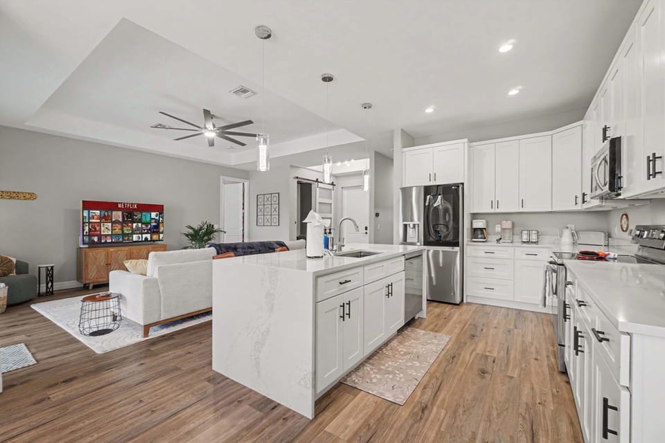 Don't miss a beat while you cook with this beautiful open concept living area. 