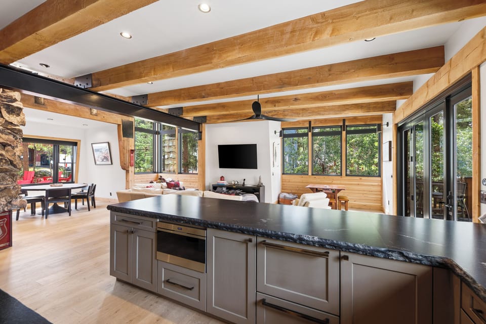 Kitchen with dining area on left in background and living area in center background