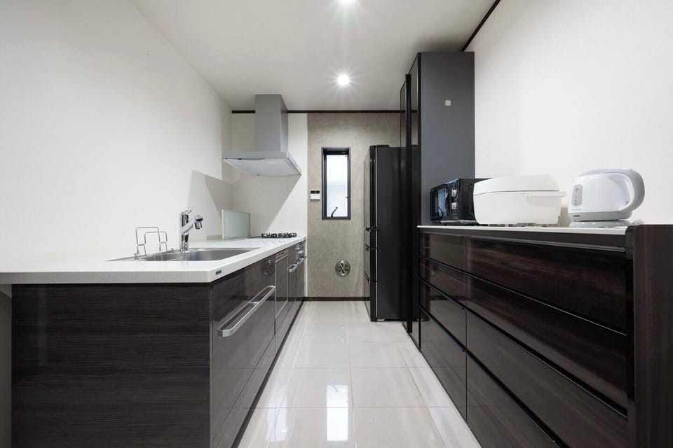 “Spacious Modern Kitchen｜Fully Equipped for Long Stays｜Microwave, Rice Cooker, Fridge, and More”

