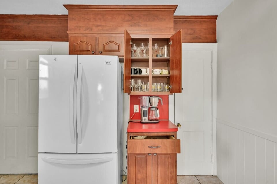 Breville coffee machine with a variety of mugs, wine glasses, and water glasses.