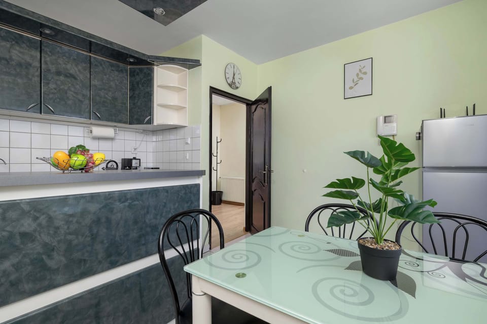 Bright kitchen and dining area with a small table, chairs, and natural light.