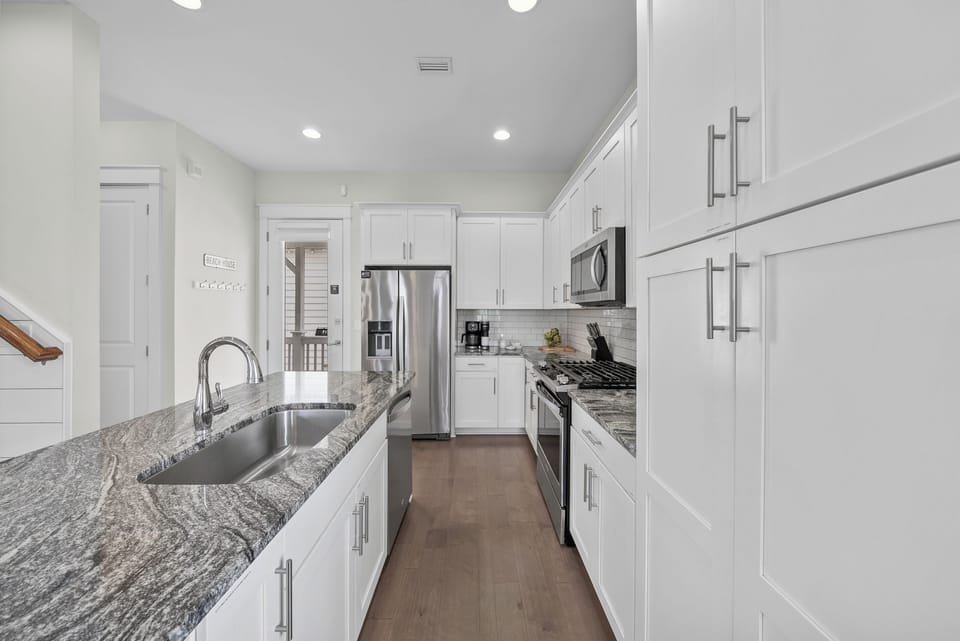 Deep counters, a full-size dishwasher, and storage to spare, so a week of real cooking never feels cramped.