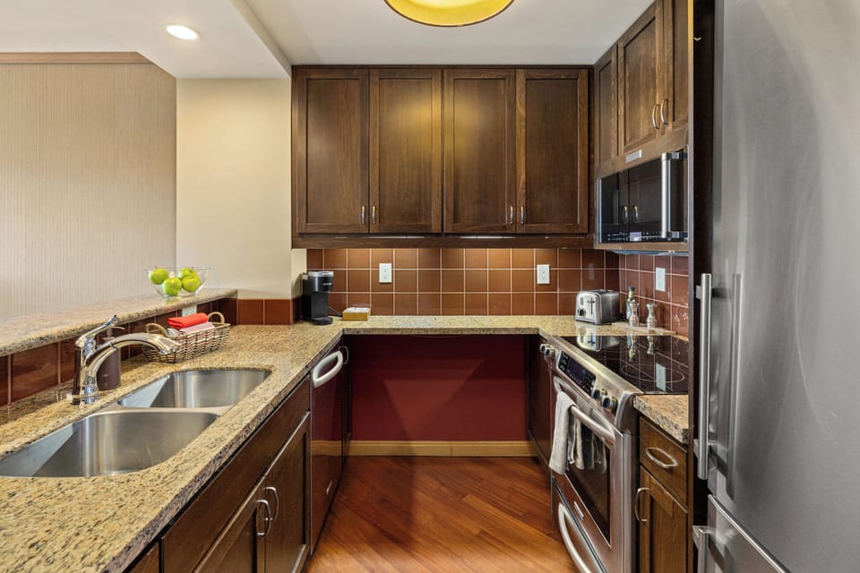 Stylish granite kitchen with stainless appliances and ample prep space