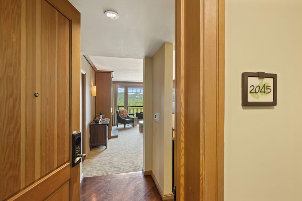 Welcoming suite entry with bright living space and scenic balcony views