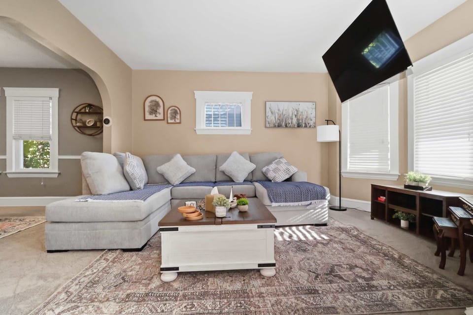 Relax together in a spacious living room with a large sectional sofa and Smart  inches 65 TV—perfect for movies, sports, and cozy evenings.