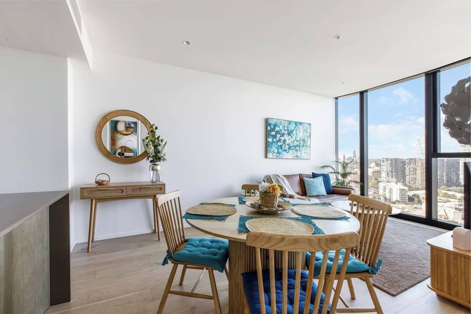 Savour each bite surrounded by sweeping city views, where the curved table and padded chairs set the stage for memorable meals and effortless conversation.