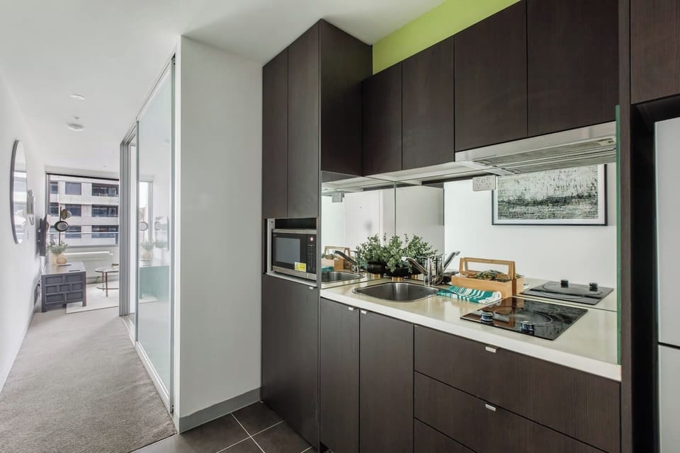 Prepare a light meal in the well-equipped kitchenette, complete with a stovetop, microwave, fridge, and essential cookware for easy cooking.