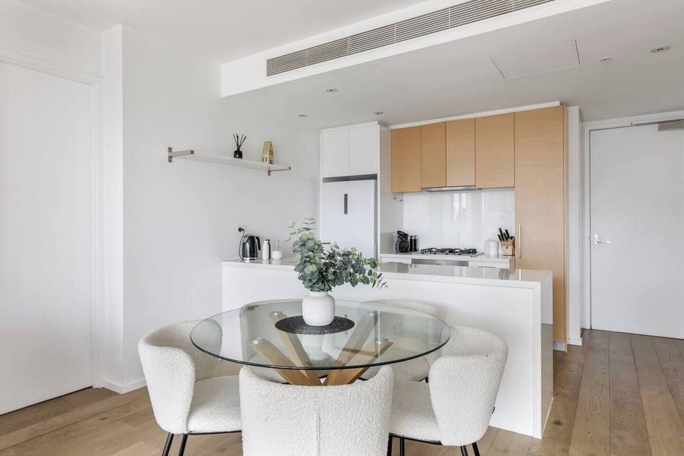 Gather around the glass dining table with its chic boucle chairs, an elegant setting for leisurely breakfasts, intimate dinners or late-night conversations.