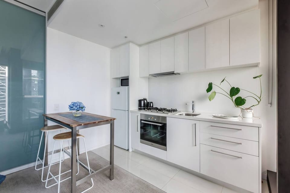 Prepare light meals in the thoughtfully designed kitchenette, featuring a gas cooktop, oven, fridge, microwave, and all cooking essentials.