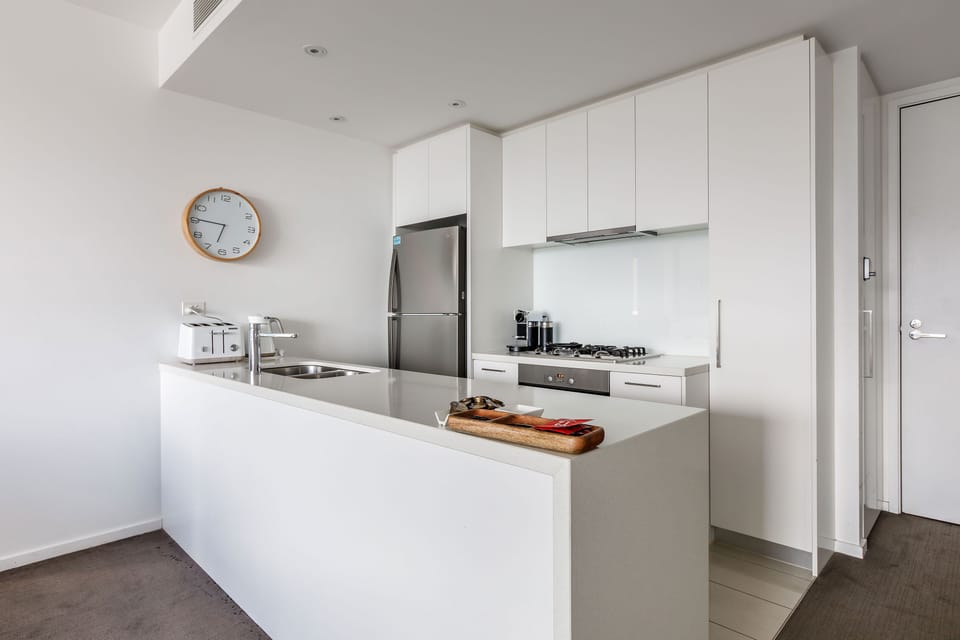 Cook with ease in the modern galley kitchen, featuring a gas stove, oven, dishwasher, and all the essentials for home-style meals.