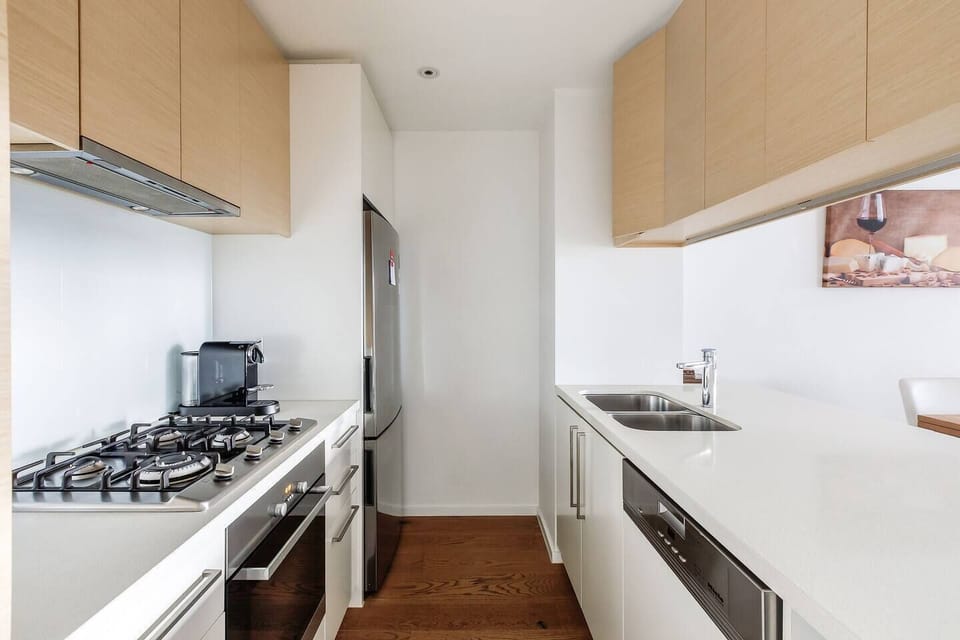 Prepare meals in the modern kitchen, featuring an oven, gas cooktop, microwave, fridge, dishwasher, kettle and toaster.