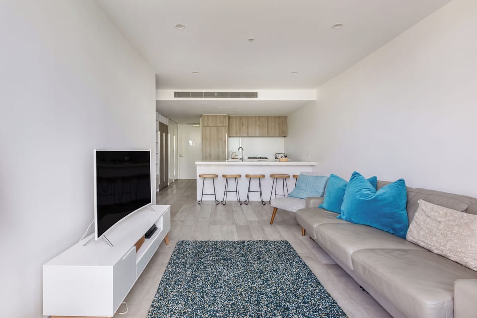 The thoughtfully designed layout connects kitchen, living, and sleeping zones, creating a calm and functional city retreat.