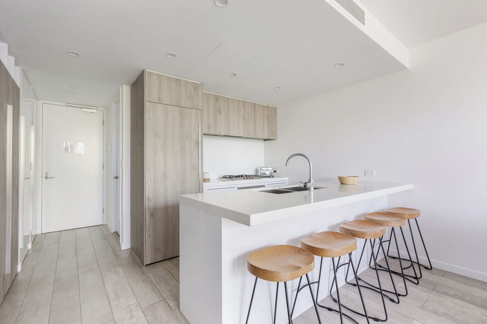 Prepare everything from simple snacks to full meals in the fully equipped kitchen featuring a gas cooktop, oven, fridge, and dishwasher.