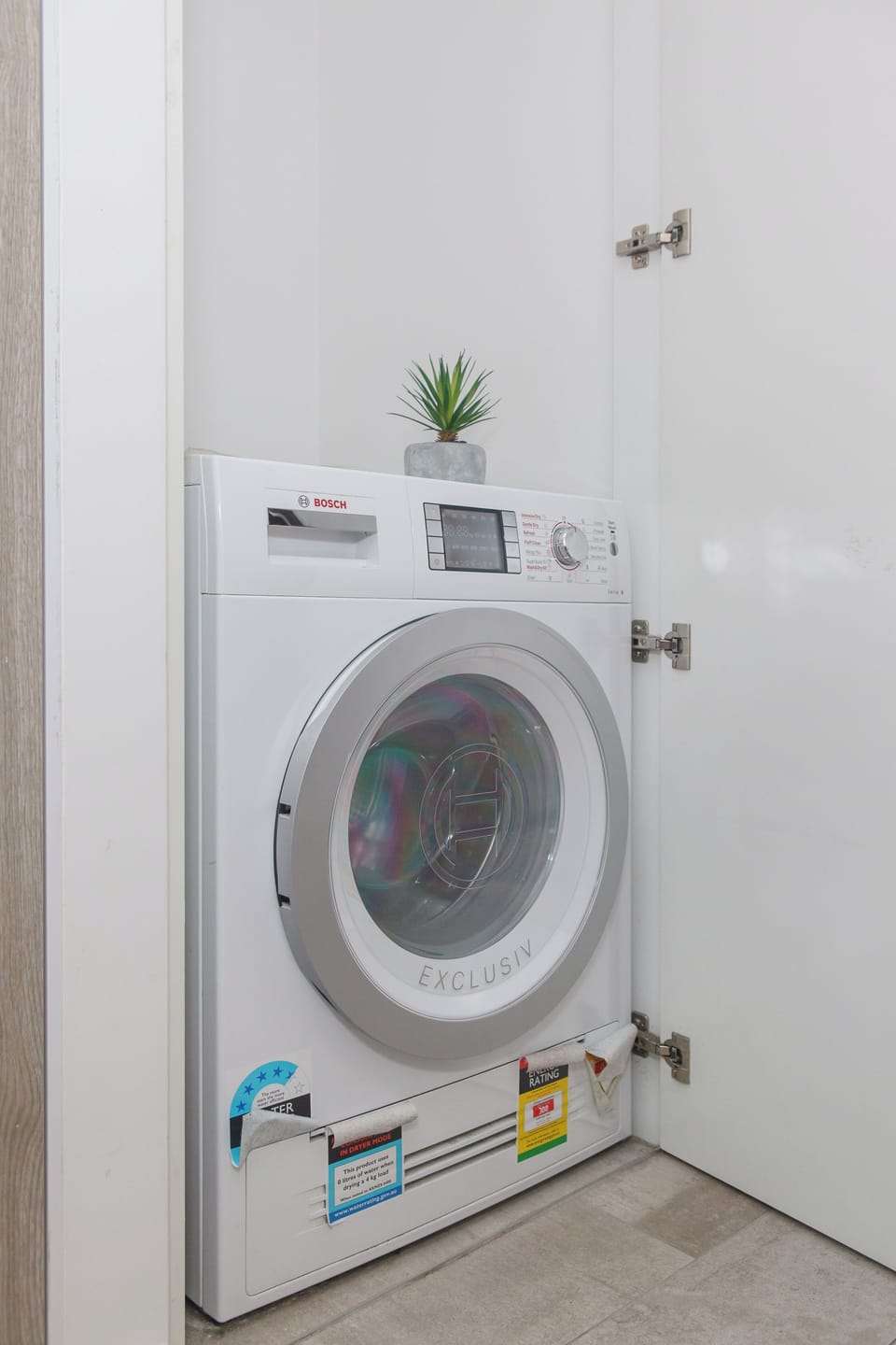A compact laundry nook with a Bosch washer-dryer combo is tucked away to make longer stays seamless.