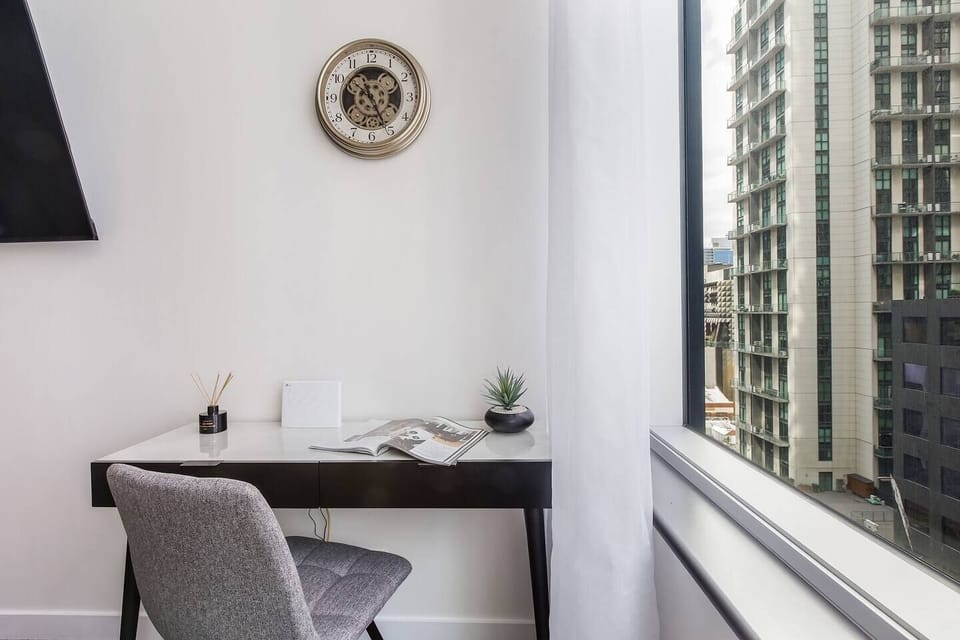 Begin your day at the dedicated workspace, a light-filled spot for focused work or planning your adventures, complete with reliable Wi-Fi and a calming city outlook.