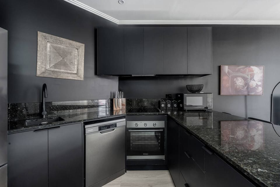 Cook with ease in the sleek kitchen, where quality appliances, including a dishwasher, oven, microwave, and everyday essentials, support everything from quick breakfasts to relaxed home-cooked meals.
