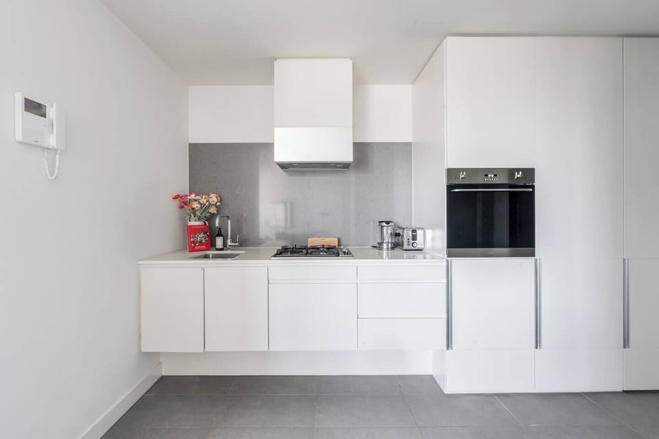 Prepare meals with ease in the modern kitchen featuring quality appliances and ample storage.