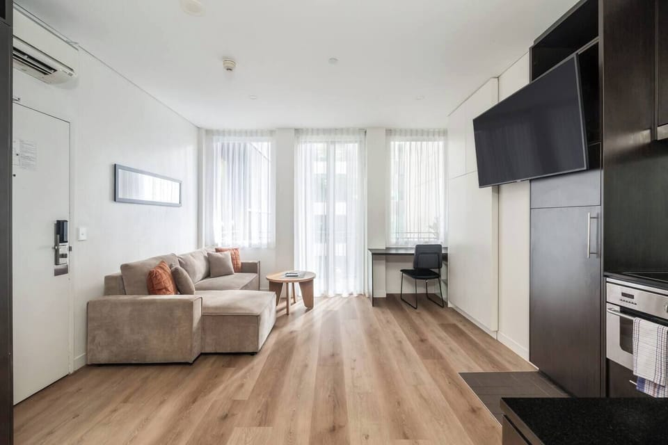 Catch up on emails or plan the day at the dedicated workspace in the living area, positioned near the windows for natural light.