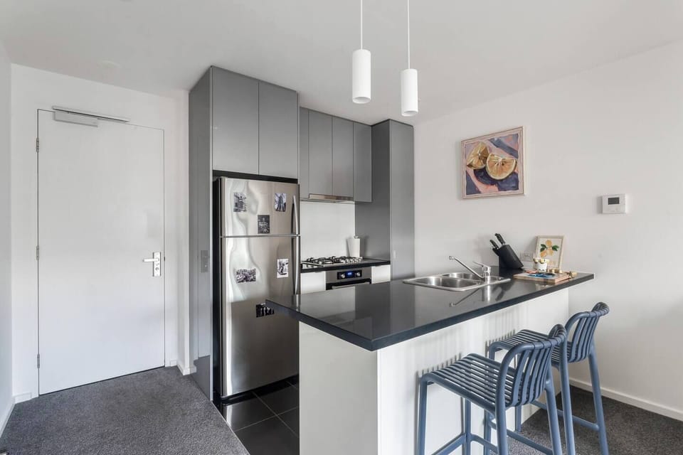 You can prepare meals with ease in the sleek kitchen, complete with a breakfast bar and quality appliances.