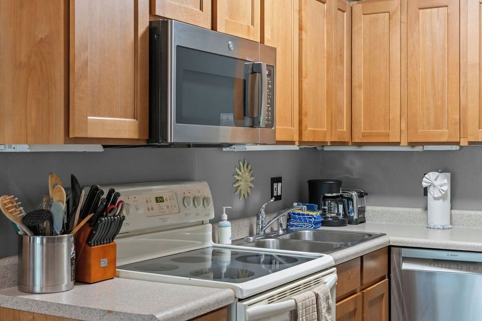 Well-equipped kitchen with full appliances and warm wood cabinetry