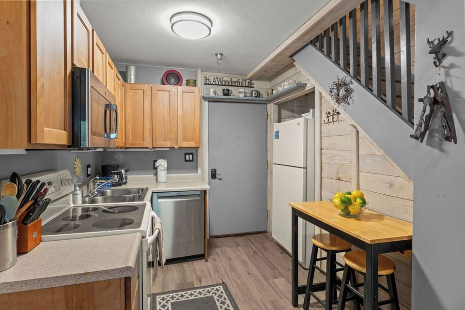 Cozy full kitchen with dining nook and warm cabin-style charm