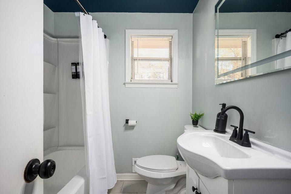 1st bathroom-Clean modern bathroom with fresh towels and essential toiletries. 