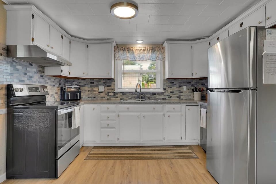 A spacious kitchen with plenty of counter space and all the essentials for preparing meals, offering both style and functionality.