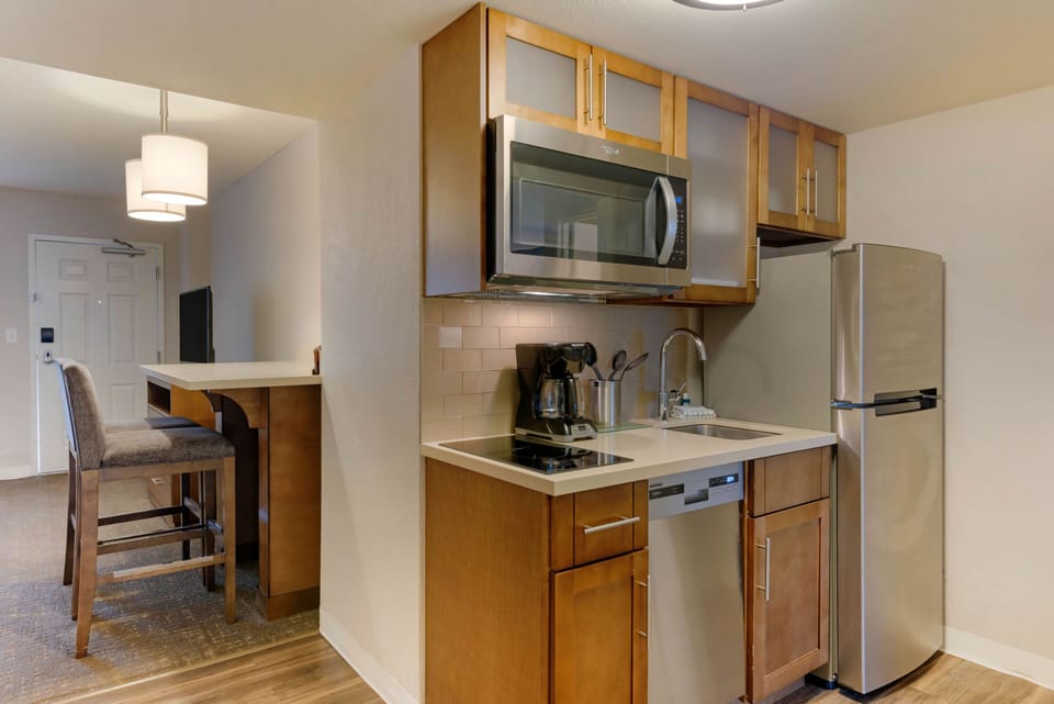 Modern kitchen layout with a microwave, dishwasher, and sink.