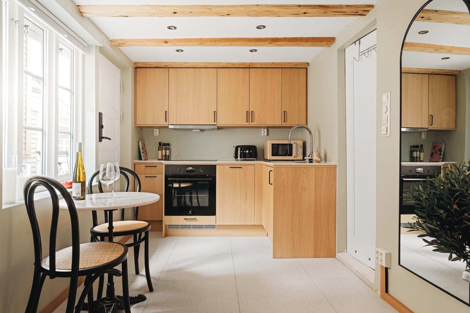 Large windows bring in natural light, highlighting the modern yet comfortable decor.