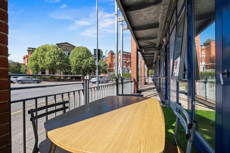 Private covered patio with outdoor seating and bright city views