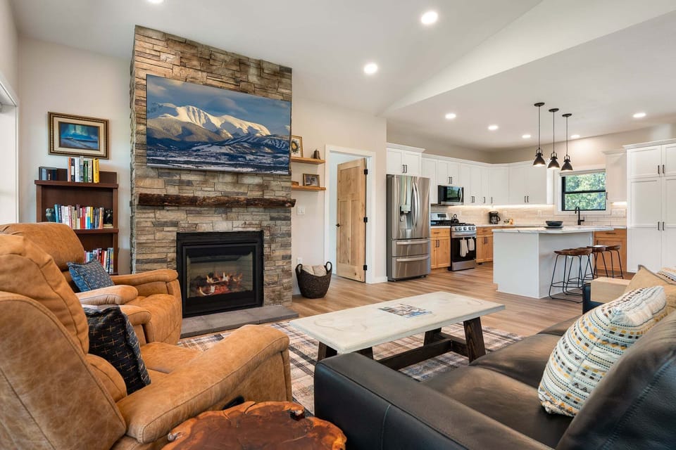 Main Floor Living Room with Gas Fireplace and 65" Smart TV