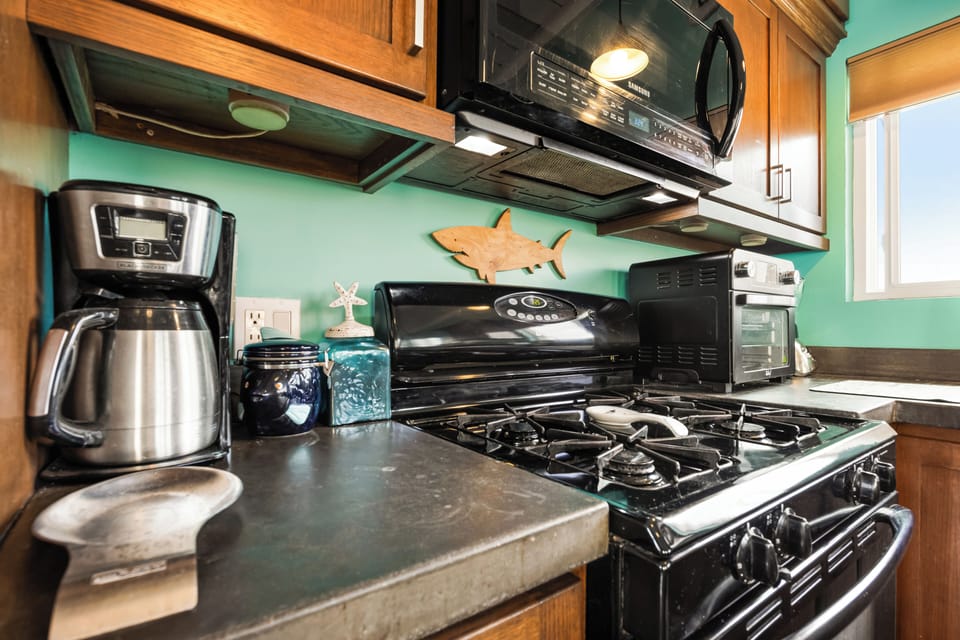 Complete with a coffee maker, gas stove, toaster oven, and all the essentials you need to cook and serve.