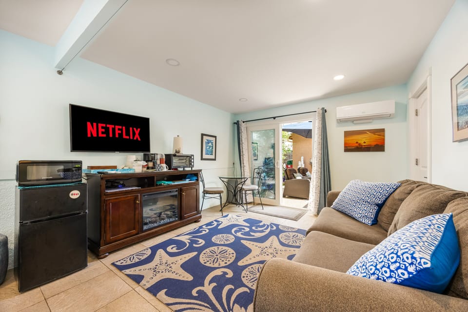 Unwind on the comfortable sofa with your favorite Netflix shows, ambient electric fireplace lighting, and direct patio access.