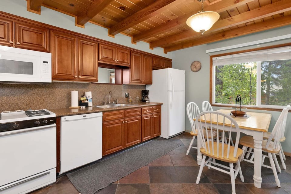 Fully equipped cabin kitchen with ample cabinetry, stove, fridge, and coffee maker—perfect for cooking meals, morning coffee, and feeling right at home on your stay.