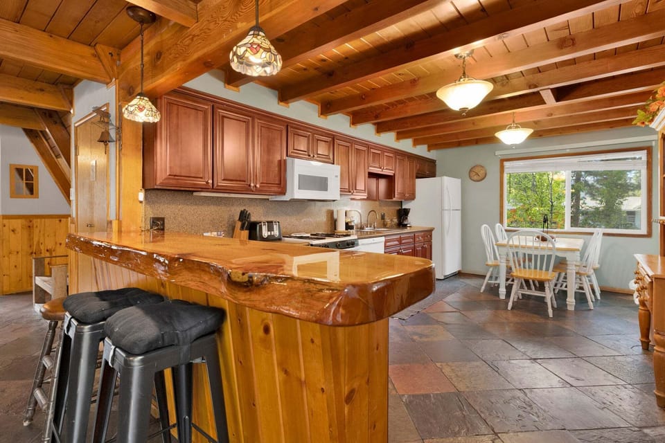 Fully equipped cabin kitchen with ample cabinetry, stove, fridge, and coffee maker—perfect for cooking meals, morning coffee, and feeling right at home on your stay.