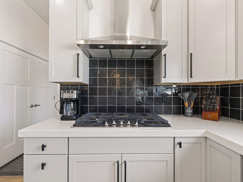 A modern, well-appointed culinary space featuring stainless steel appliances, ample counter space, and quality cabinetry. The open layout creates an inviting space for meal preparation while staying connected to the rest of the home. Clean lines and contemporary finishes make this kitchen both functional and stylish for entertaining.