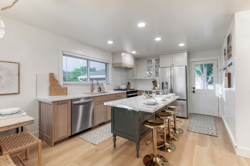 Bright modern kitchen with island seating and stainless appliances