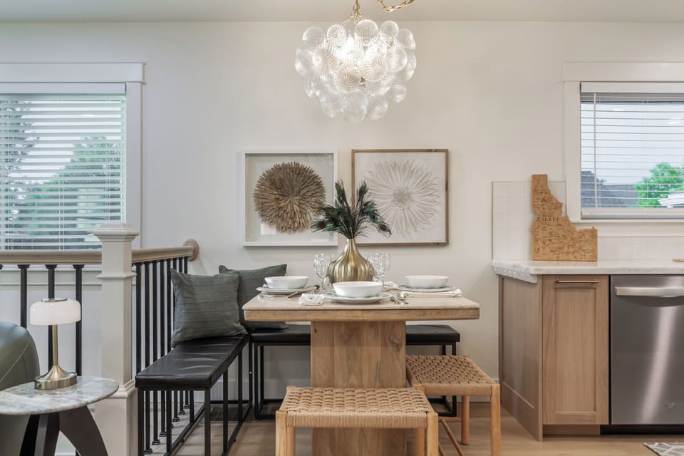 Bright designer dining nook with statement chandelier and cozy seating