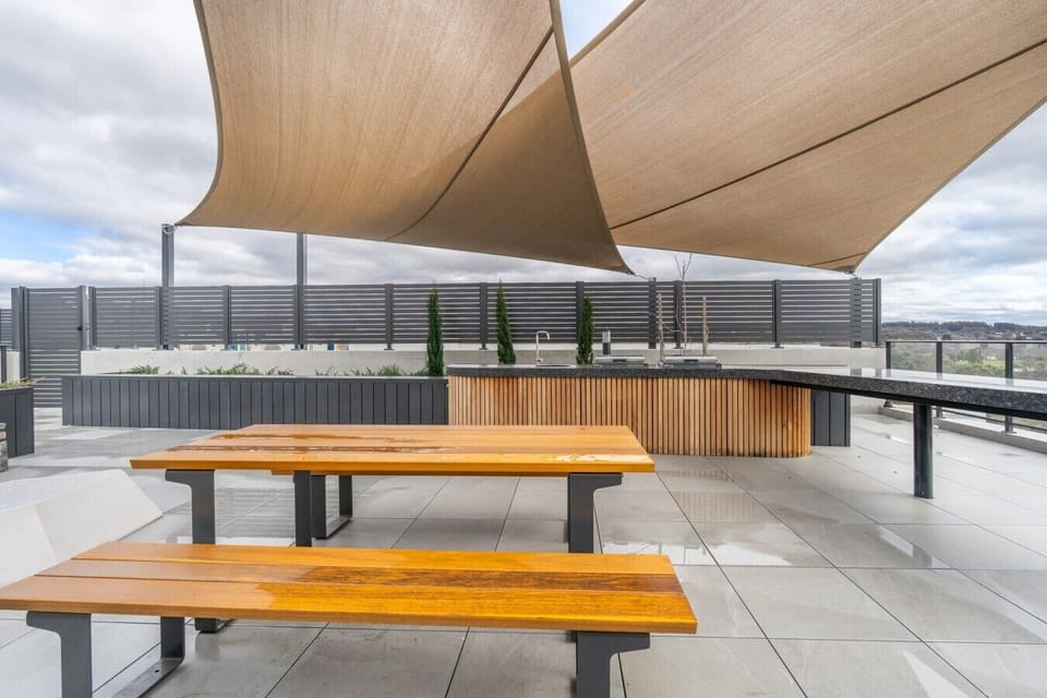 Gather with friends or family in this spacious rooftop setting, offering comfortable seating, shade and an inviting atmosphere for outdoor relaxation.