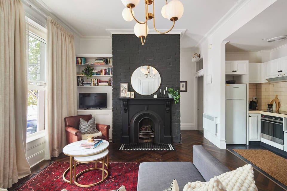 Relax in the inviting living area where a decorative fireplace and warm lighting add character and atmosphere to your evenings indoors.