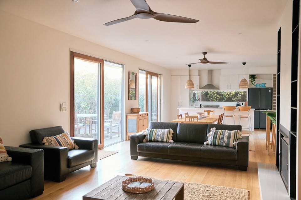 Let the indoors spill outward as glass doors open wide, offering a seamless step from lounging inside to fresh air on the deck.