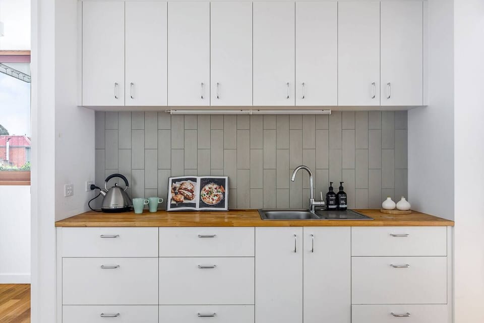 Discover a compact kitchenette perfect for heating up leftovers or whipping up a quick cup of coffee.