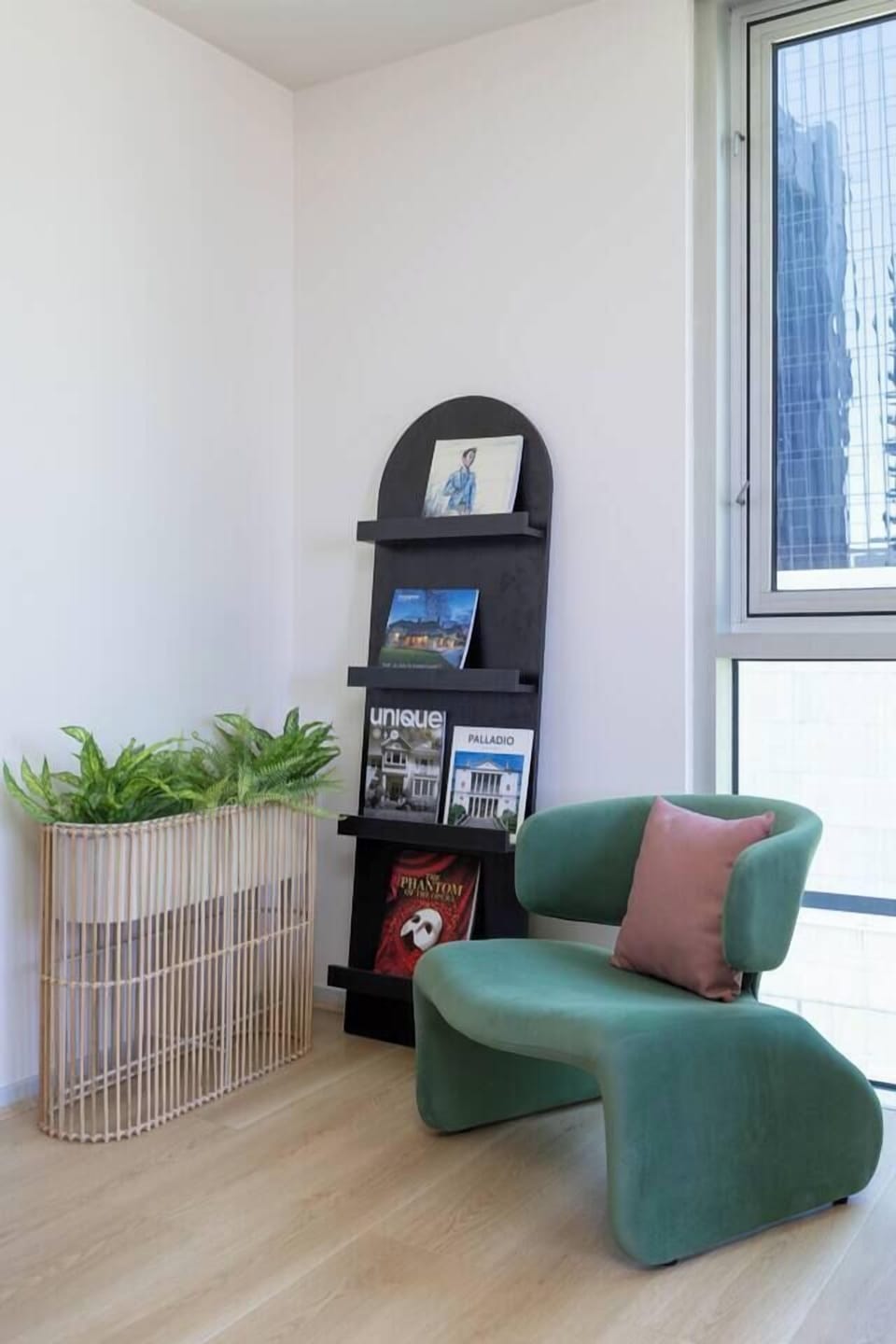 A sculptural chair by the window forms a quiet corner for slow mornings, afternoon reads, or slow moments above Collins Street.