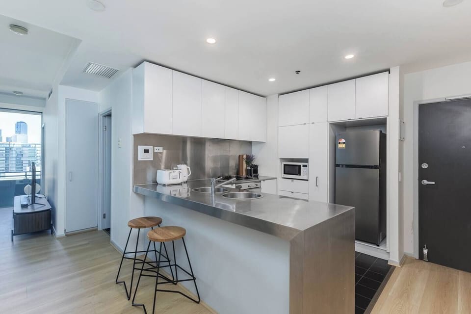 The kitchen is fully equipped with essential appliances, including an oven, cooktop, microwave, dishwasher, refrigerator, kettle, toaster, and cooking essentials, making self-catering easy.