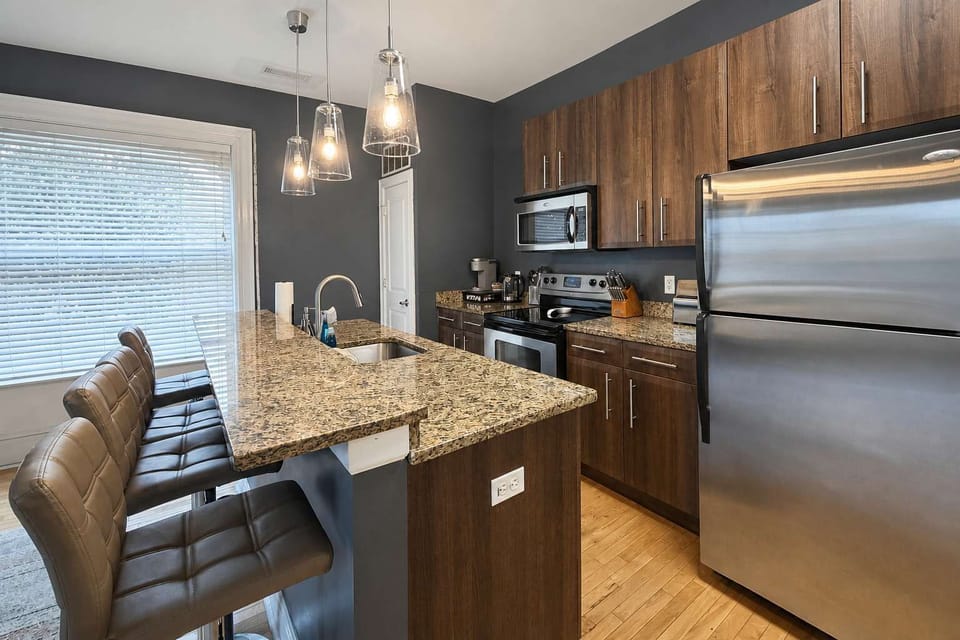 Kitchen island — gooseneck faucet, prep space, and bar seating